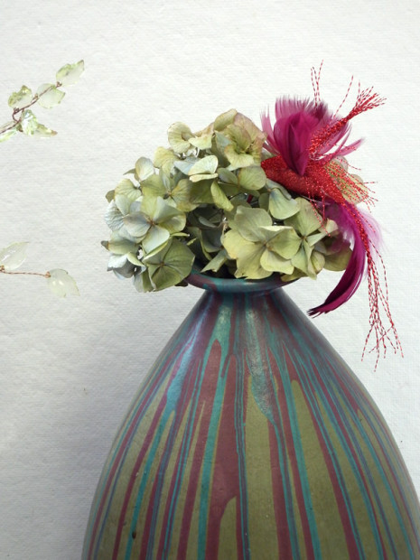 Large multicolored striped vase with dried hydrangeas